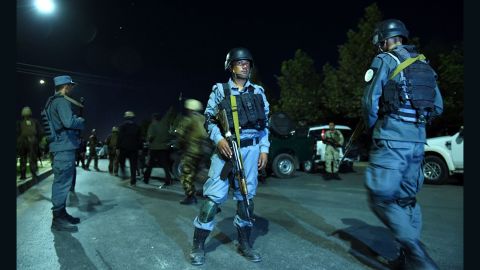 Security personnel stand guard Wednesday night at the American University of Afghanistan in Kabul.
