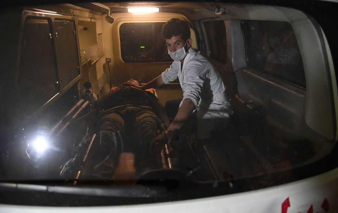 An injured Afghan man being treated in an ambulance near the site of an attack by the Taliban that targeted the American University of Afghanistan in Kabul on August 24, 2016.