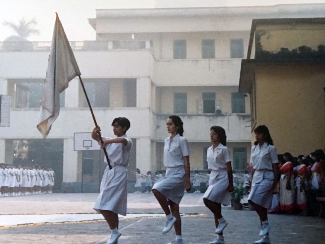 Head girl Mallika Kapur (L) carries the Loreto House school flag. 