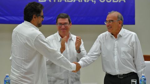 Sealed with a handshake: Colombian government representative Humberto de la Calle, right, and FARC commander Ivan Marquez greet each other after signing a peace deal in Havana.