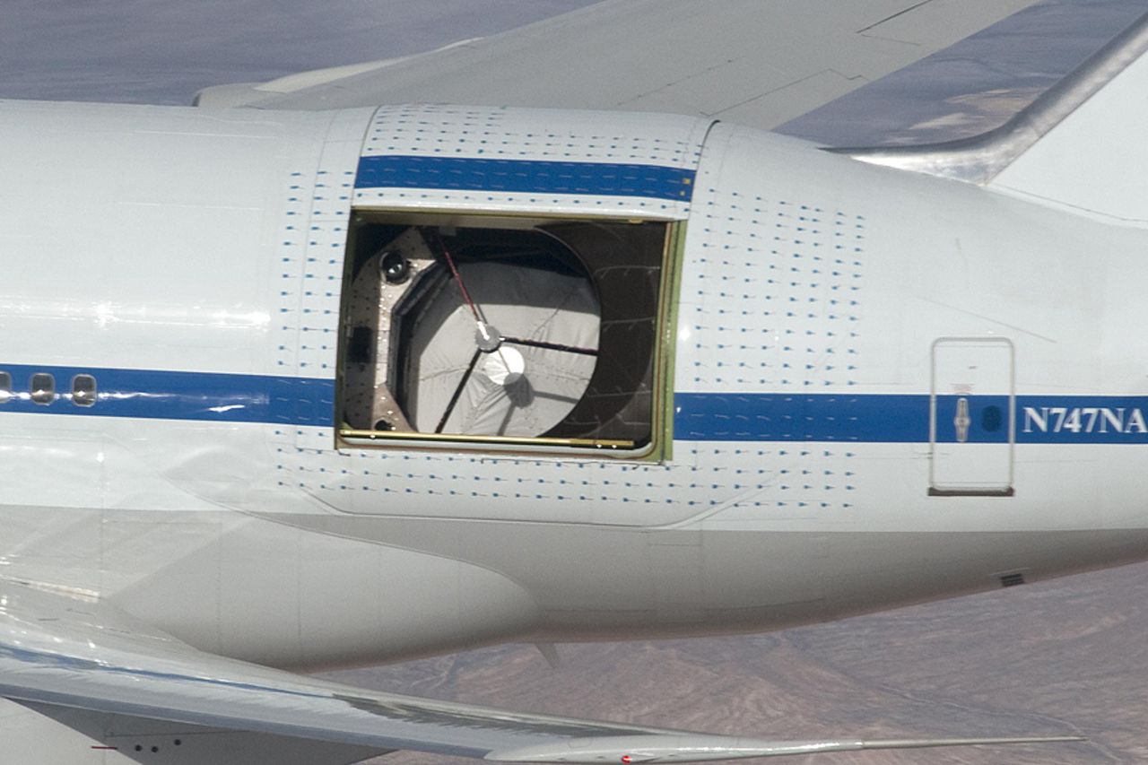 At 35,000 feet, a custom door opens on SOFIA's left side, revealing the telescope in an unpressurized part of the aircraft. All airplane observatories position their telescopes on left side, said flight planner Allan W. Meyer. Flying observatories get more data that way because they can slow down the rising and setting of objects by heading in that direction.