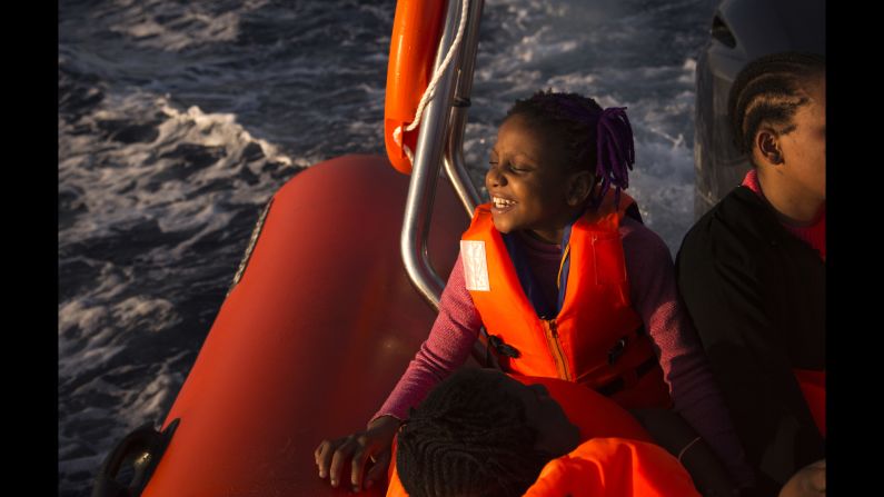 Sira, a 9-year-old Nigerian girl, smiles after being rescued by the nongovernmental organization Proactiva Open Arms in an operation in the Mediterranean Sea about 17 miles north of Sabratha, Libya, on Saturday, August 20. 