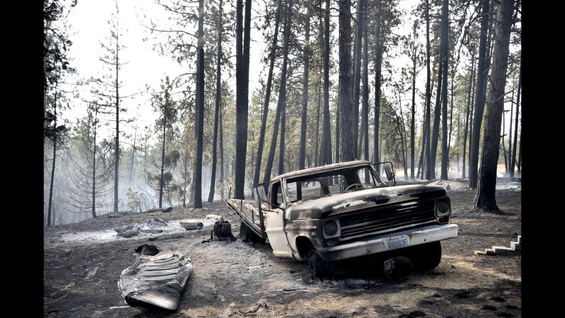 A charred truck is seen near the home of Julie and Art Thayer near Valleyford, Washington, on Monday, August 22. The Thayers had been hiking over the weekend and returned home Sunday night to find their home destroyed. Wildfires in the Spokane area have destroyed more than a dozen homes, <a href="http://bigstory.ap.org/article/aa79c2dc9bd147a0ad0edc2560338a3e/crews-battle-blazes-california-washington-state-wyoming" target="_blank" target="_blank">according to The Associated Press</a>.