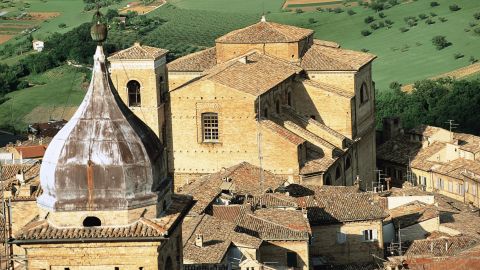 In a photo taken before the earthquake, the Church of San Giuliano is seen behind the bell tower of the Church of St. Paul in Macerata.