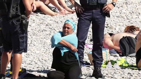 Police confront a woman in a burkini on a beach in Nice last week.