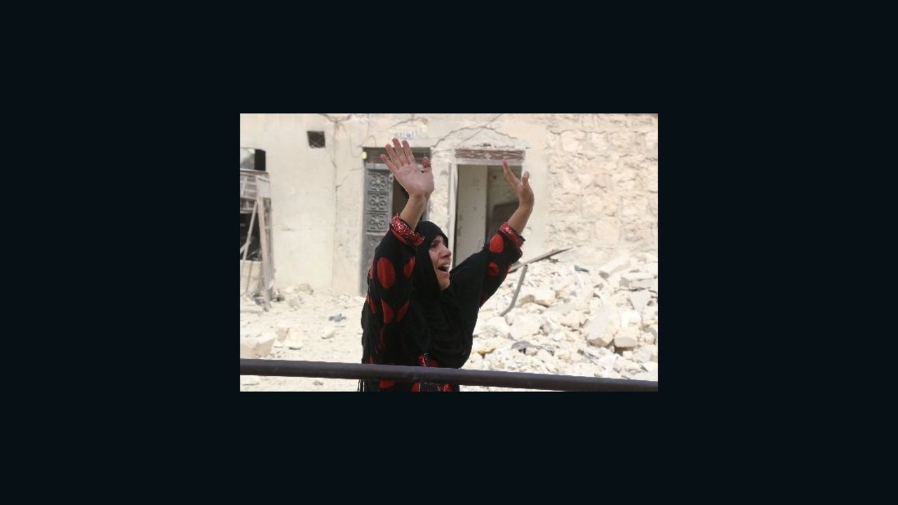 A woman mourns her dead son after a barrel bomb in Aleppo, Syria.