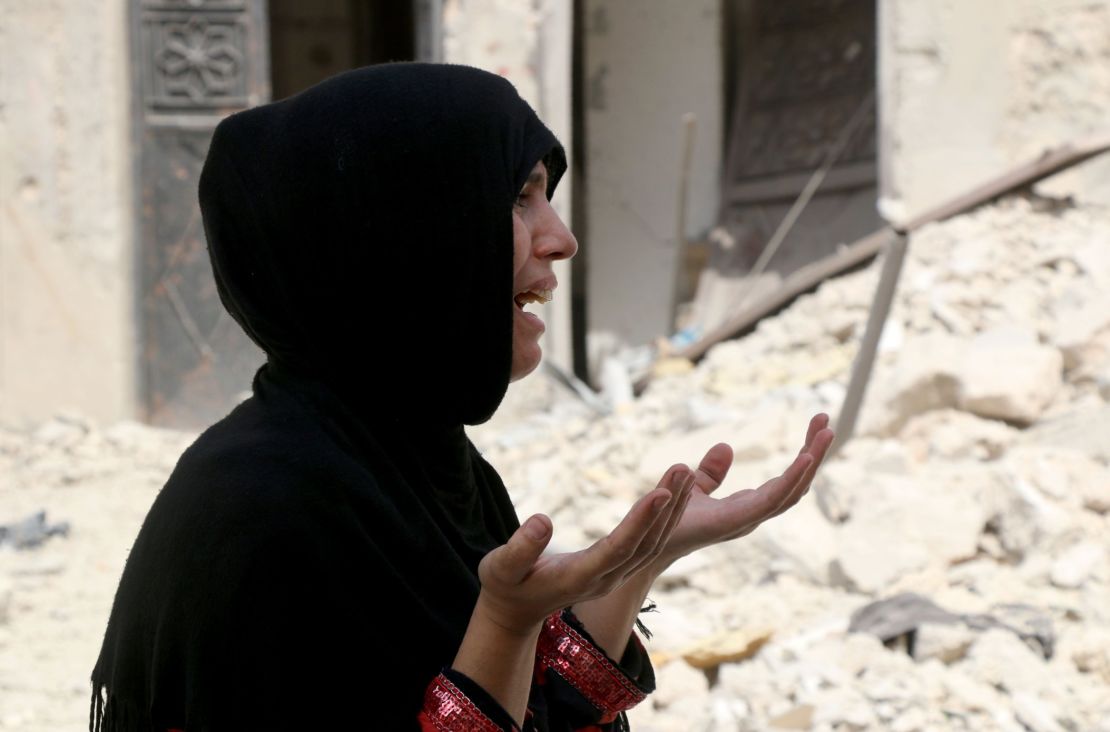 A Syrian woman reacts following a reported  barrel bomb attack on the Bab al-Nairab neighbourhood of the northern Syrian city of Aleppo.