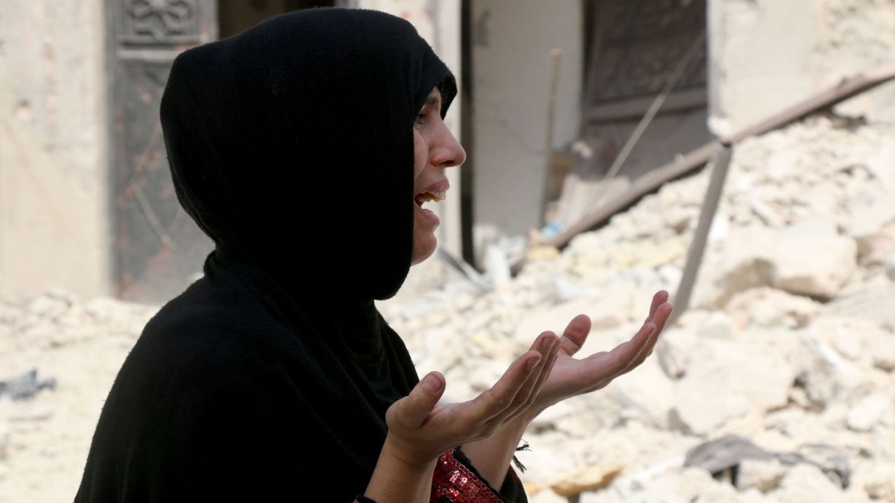A Syrian woman reacts following a reported  barrel bomb attack on the Bab al-Nairab neighbourhood of the northern Syrian city of Aleppo.