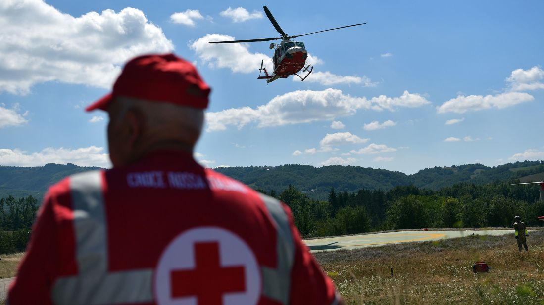 An emergency services helicopter takes off in Amatrice as rescuers continue the search for survivors.