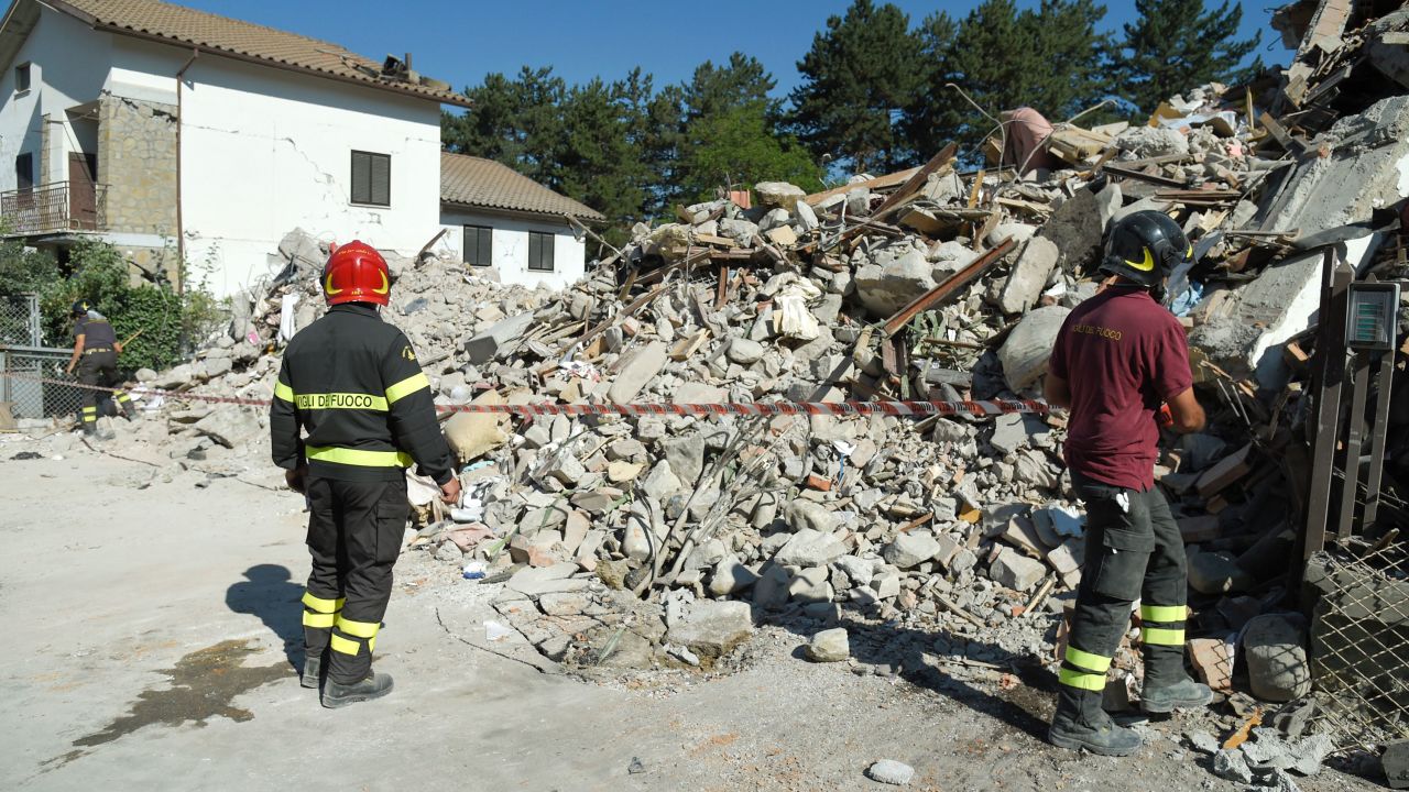 Firefighters cordon off an area around the rubble from a destroyed building in Amatrice on August 26. 