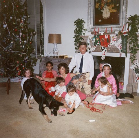 President John F. Kennedy and first lady Jacqueline Kennedy pose with their family and their dogs, German shepherd Clipper and Welsh terrier Charlie, on Christmas Day at the White House in 1962.