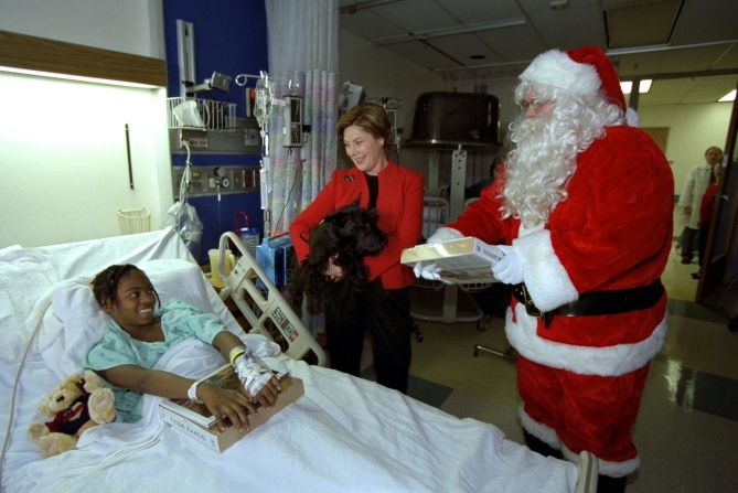 First lady Laura Bush, her Scottish terrier, Barney, and Santa Claus visit Brittanie Morris at the Children's National Medical Center on December 12, 2002, in Washington.