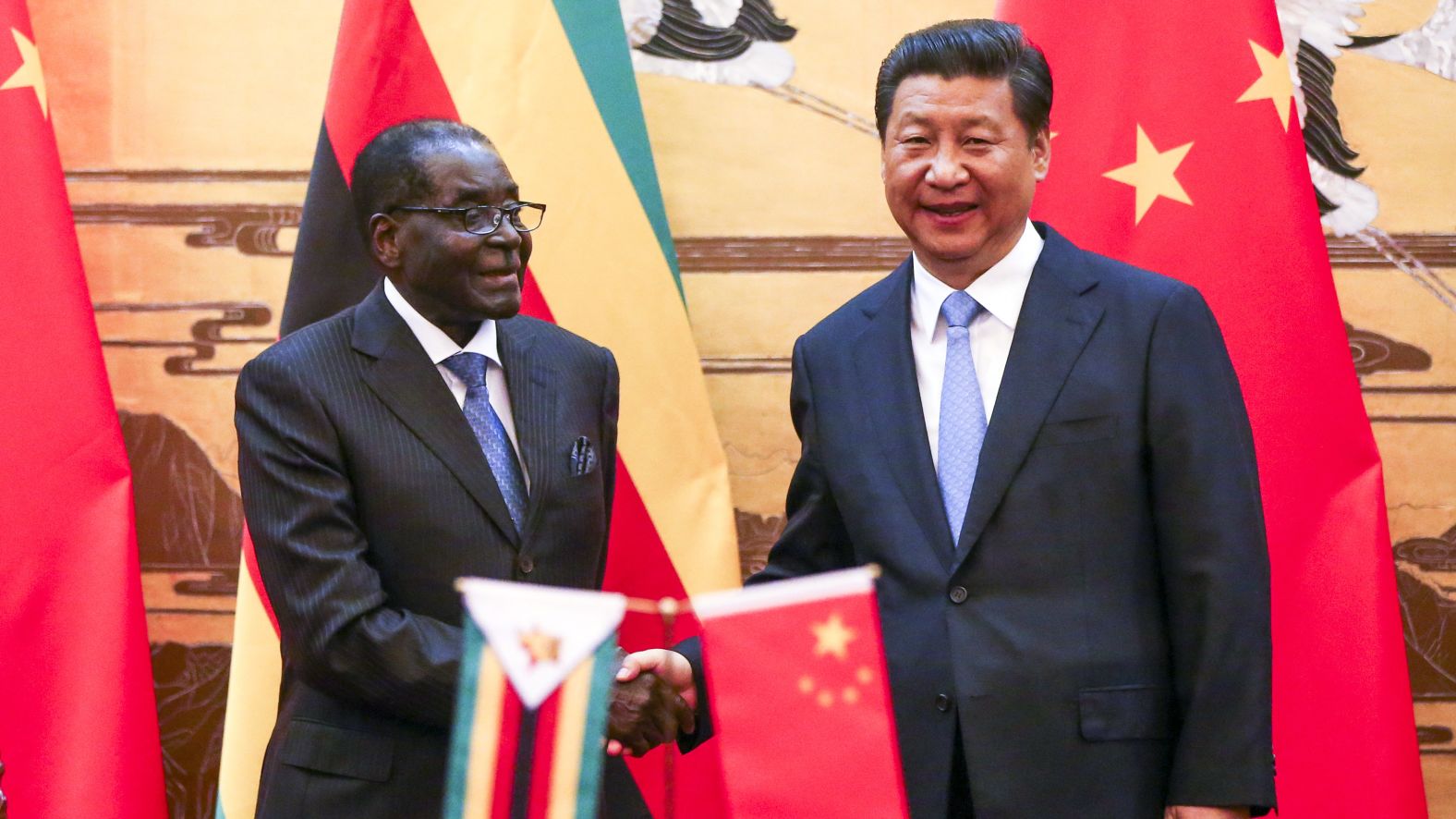 Mugabe and Chinese President Xi Jinping participate in a signing ceremony in Beijing in 2014.