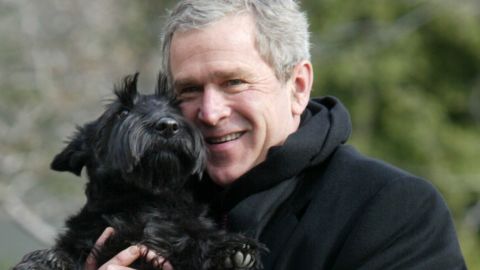 Bush holds up his dog Barney upon his arrival at the South Lawn of the White House on February 3, 2002.