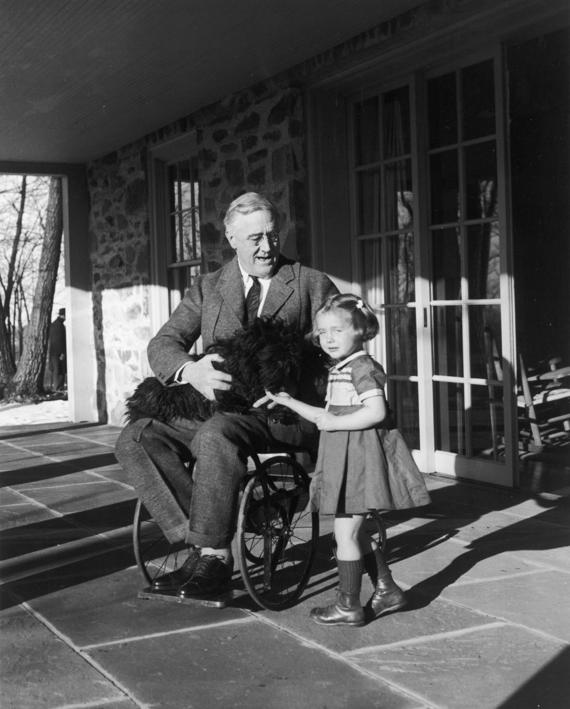 Roosevelt poses with his dog Fala and a friend granddaughter, Ruthie Bie, at Hill Top Cottage in Hyde Park New York, circa 1940s.