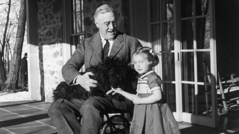 Roosevelt poses with his dog Fala and a friend granddaughter, Ruthie Bie, at Hill Top Cottage in Hyde Park New York, circa 1940s.