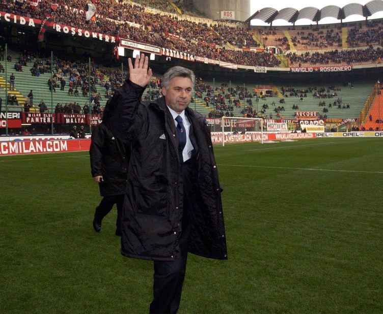 Ancelotti acknowledges the crowd as he walks out for his first match as AC Milan manager in 2001, the first of his 423 games in charge of the club. 