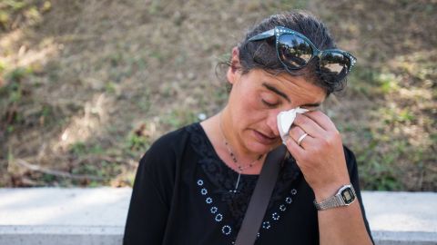 Cecilia d'Alessio takes a moment to grieve for three family members who died in the earthquake in Amatrice. She owns a home in Amatrice city center which she says has now been destroyed.
