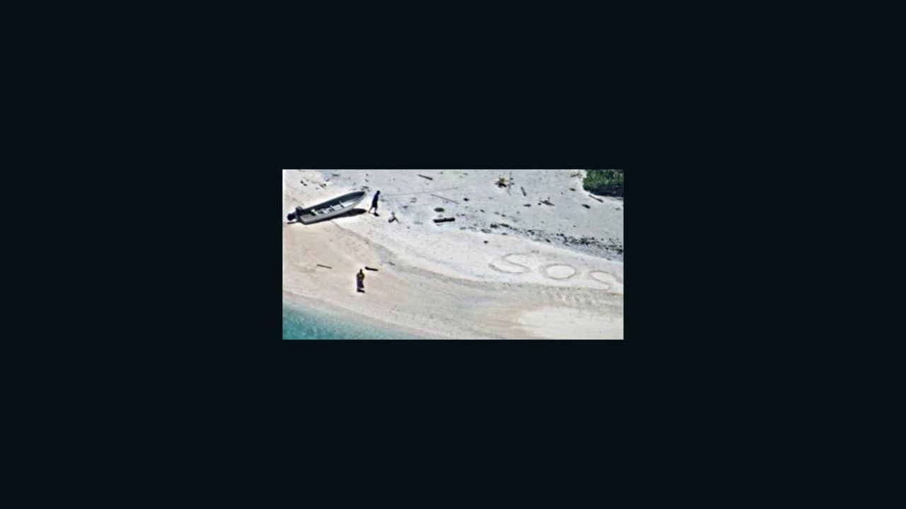 Two stranded mariners were rescued after a US Navy aircraft crew spotted SOS etched into the sand while flying over a deserted beach in Micronesia.