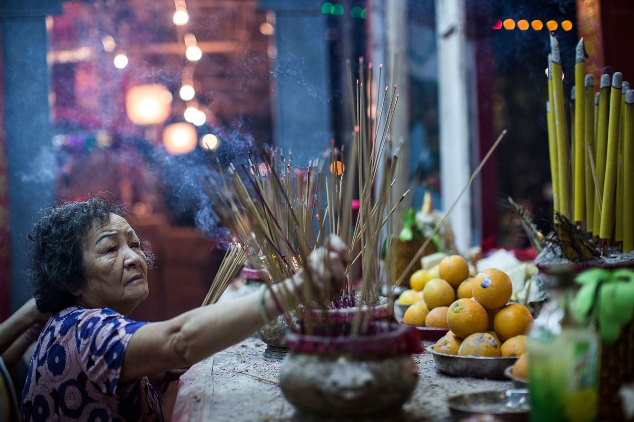 A woman makes offerings at a park during the month of the Hungry Ghost Festival on August 14, 2015 in Hong Kong. One of the main activities of the Chinese festival includes paying respects with food offerings to hungry ghosts.