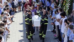 Firefighters carry the coffin of 9-year-old Giulia Rinaldo outside the gymnasium where the state funeral service for some of the victims of the earthquake that hit central Italy last Wednesday took place, in Ascoli Piceno, Italy, Saturday, Aug. 27, 2016. Italians bid farewell Saturday to victims of the devastating earthquake that struck a mountainous region of central Italy this week. (AP Photo/Gregorio Borgia)