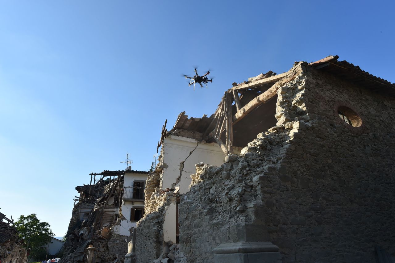 A drone controlled by Italian firefighters flies over damaged houses in San Lorenzo, Italy, on August 27.