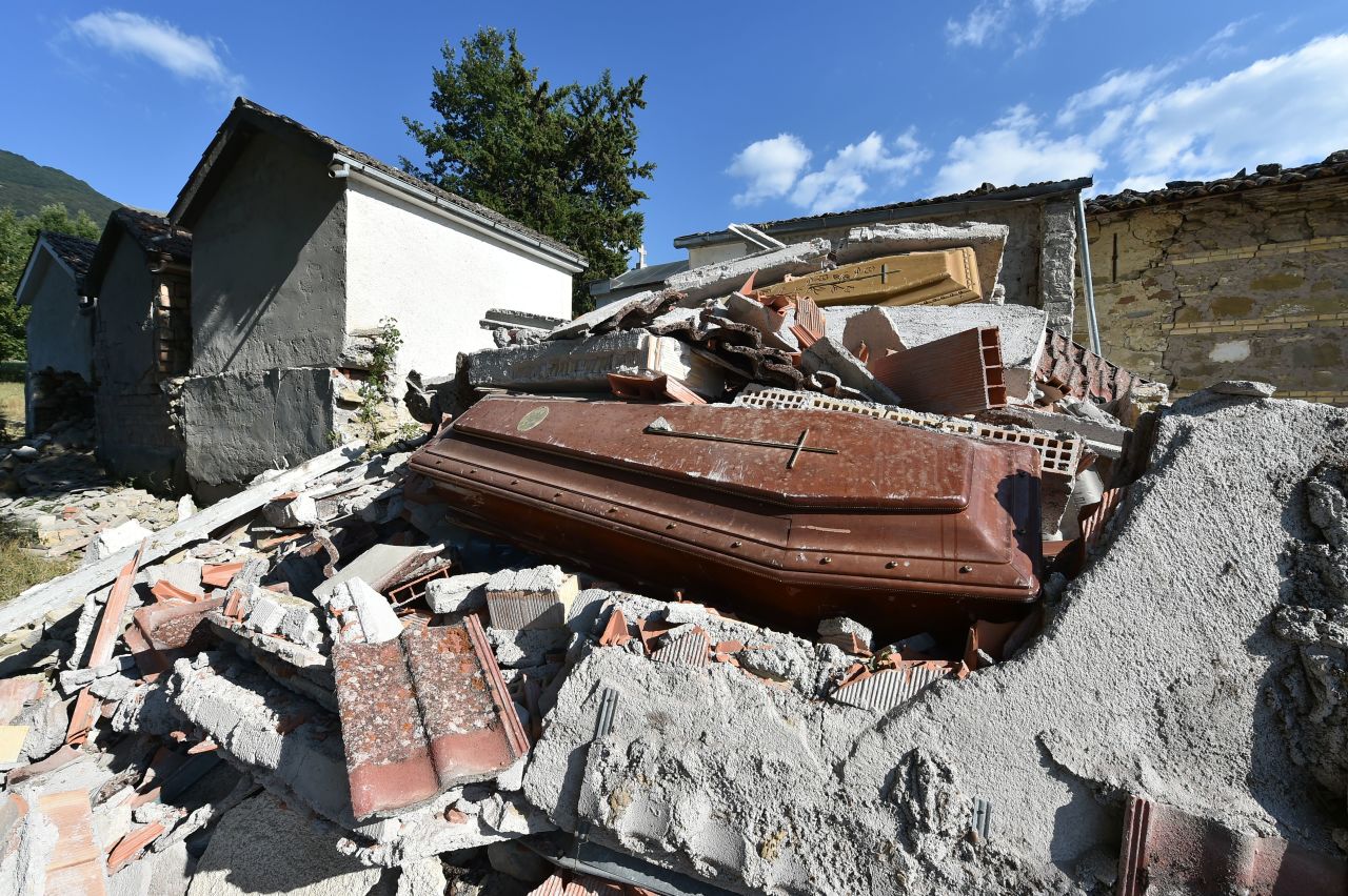 Damaged coffins and rubble are seen at the cemetery of Sant'Angelo, Italy, on August 27. 