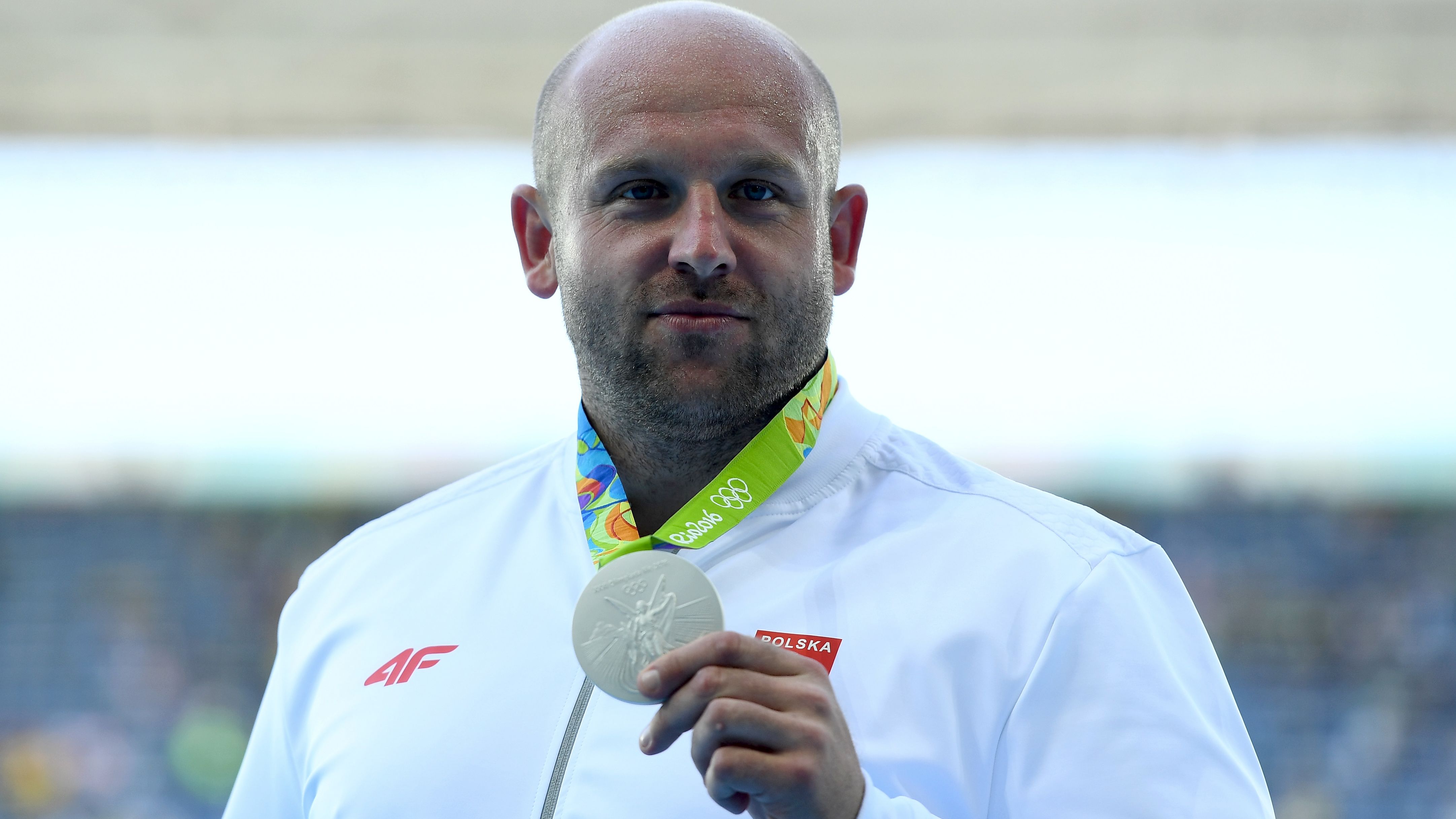 Silver medalist Piotr Malachowski decided to auction off his medal after learning about a little boy's battle with eye cancer. 