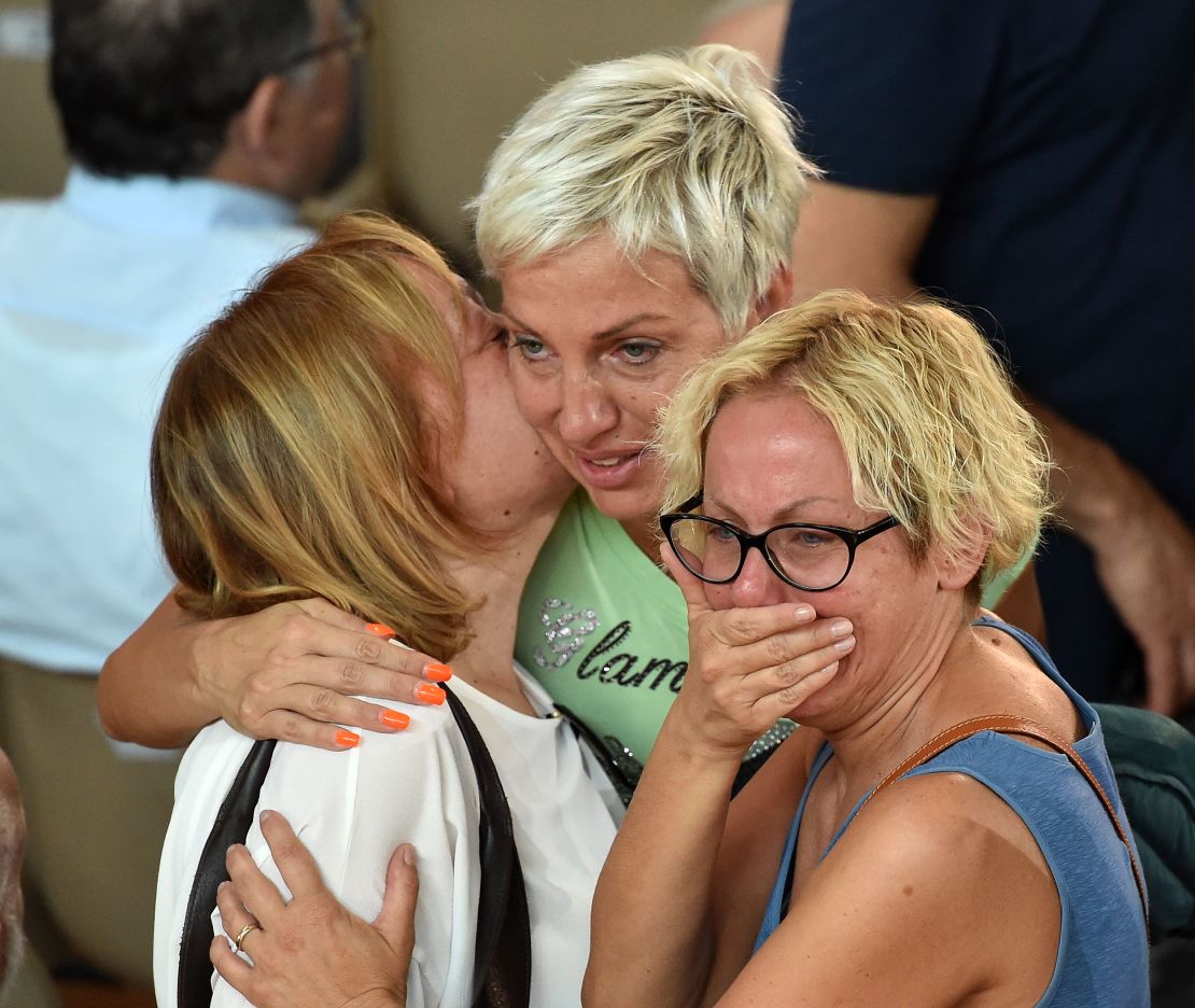 Mourners grieve at Italy's state funeral for earthquake victims. 