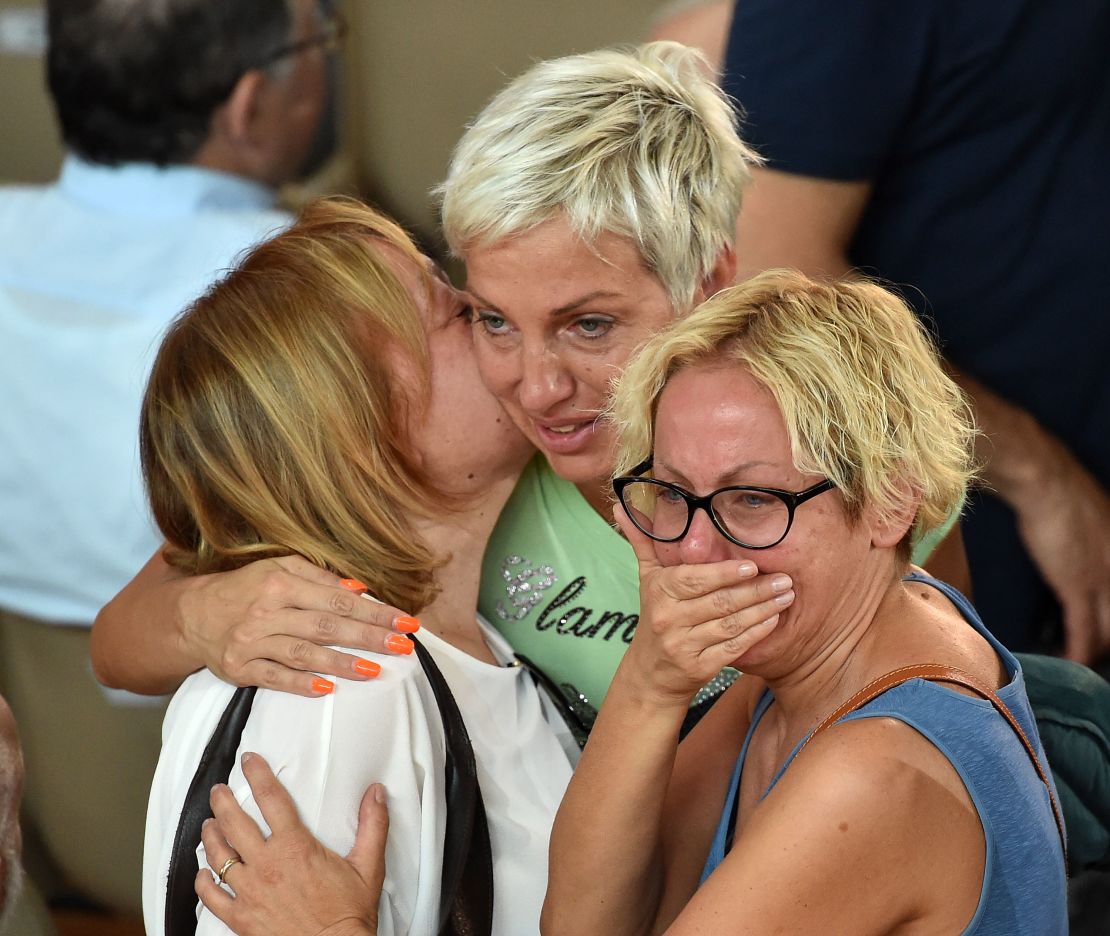 Mourners grieve at Italy's state funeral for earthquake victims.