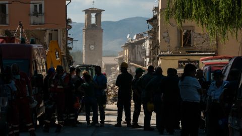 Emergency crews huddle near the iconic Amatrice clock tower still standing amid the rubble. The frozen hands of the clock rest at the time of the earthquake: 3:36 a.m. local time.
