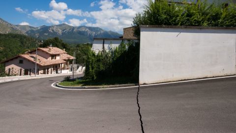 A neat fracture line in the pavement is a telling sign of the earth's violent movement below the streets of Amatrice.