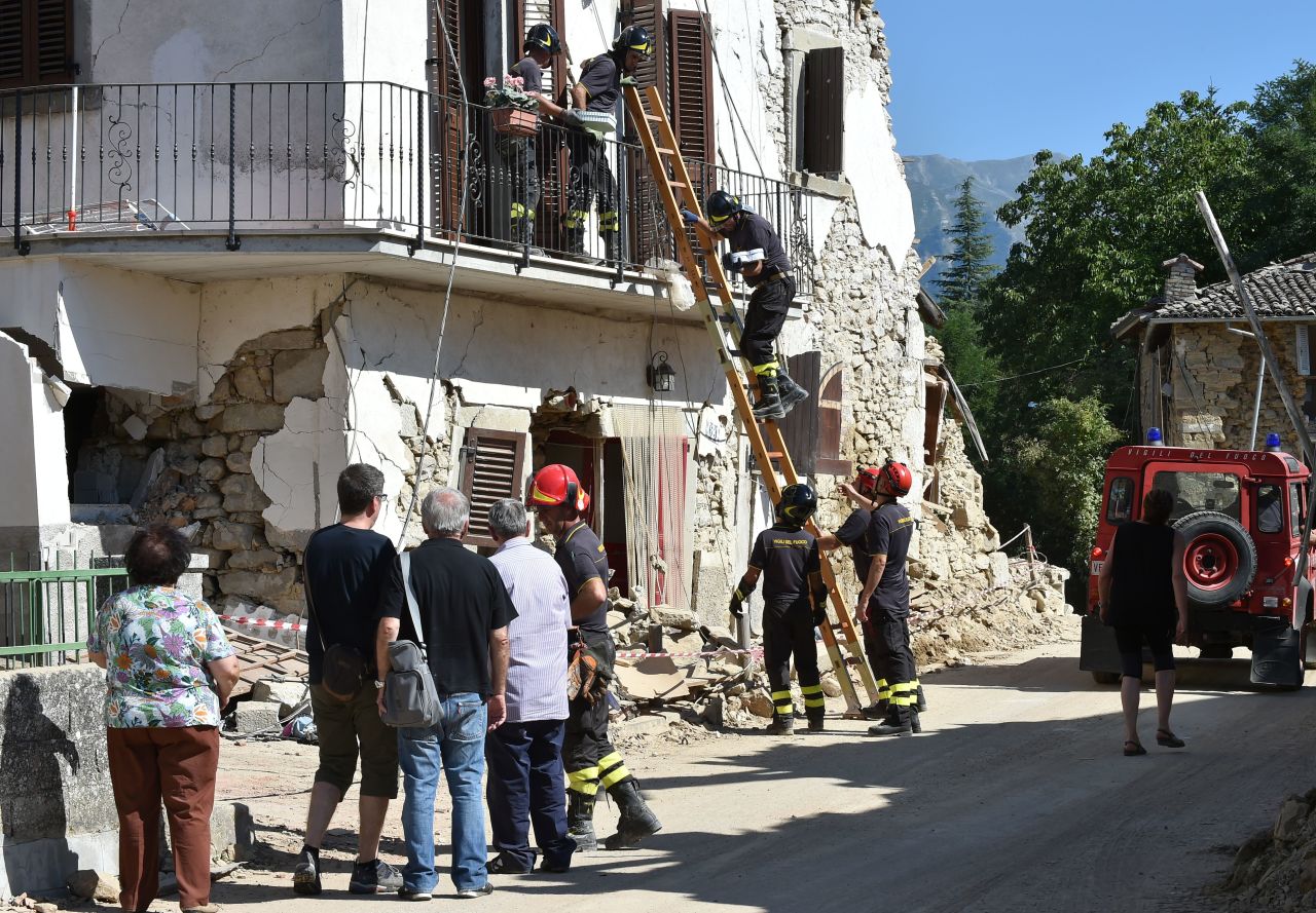Firefighters help residents recover personal belongings from damaged houses in the village of Rio, Italy, on Sunday, August 28.  A 6.2-magnitude earthquake struck central Italy on Wednesday, killing more than 290 people. The death toll is expected to rise as rescue teams reach remote areas.