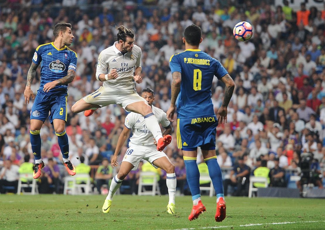Real Madrid's Gareth Bale  heads past Pablo Hernandez of Celta Vigo.