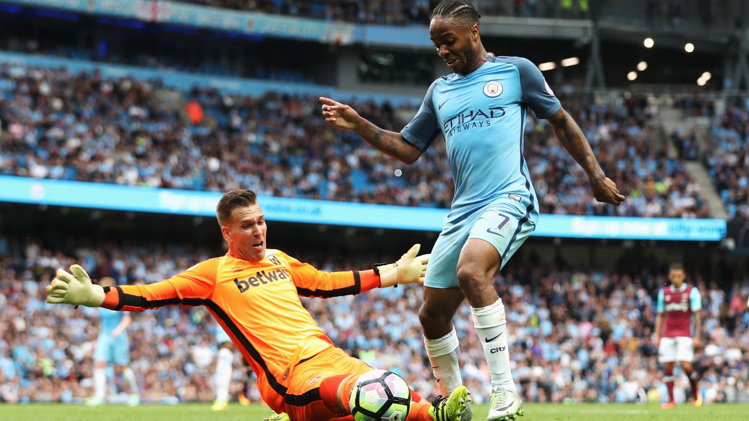 Manchester City's Raheem Sterling rounds West Ham goalkeeper Adrian to score his second goal.