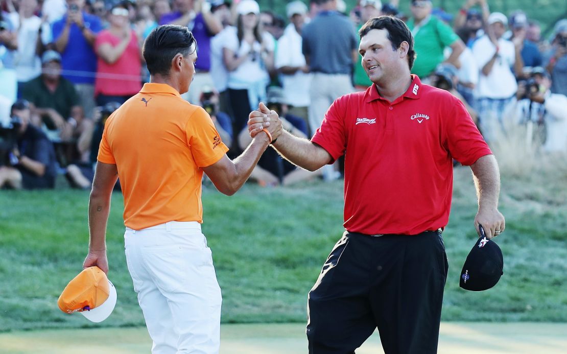  Patrick Reed (R) greets Rickie Fowler on the 18th green after Reed won The Barclays on August 28, 2016.