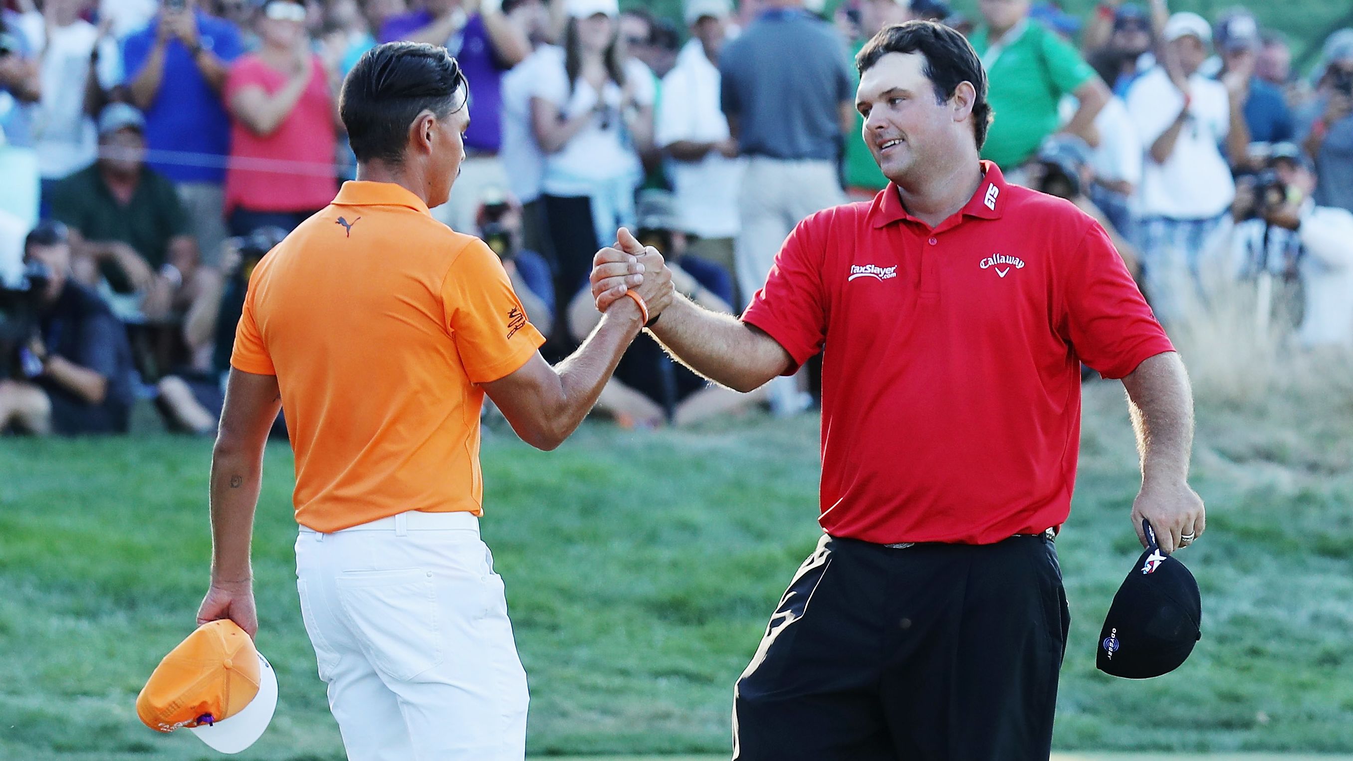  Patrick Reed (R) greets Rickie Fowler on the 18th green after Reed won The Barclays on August 28, 2016.