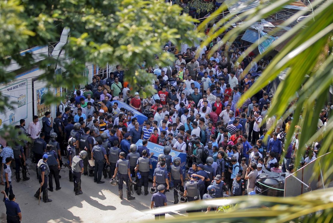 A crowd gathered near the scene of the raid. Police staged an hour-long gun battle before shooting dead three suspected militants.