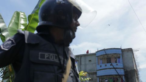 Bangladesh police stand guard near the building that was raided.
