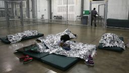 A girl from Central America rests on thermal blankets at a detention facility run by the U.S. Border Patrol on September 8, 2014 in McAllen, Texas. The Border Patrol opened the holding center to temporarily house the children after tens of thousands of families and unaccompanied minors from Central America crossed the border illegally into the United States during the spring and summer. Although the flow of underage immigrants has since slowed greatly, thousands of them are now housed in centers around the United States as immigration courts process their cases.  