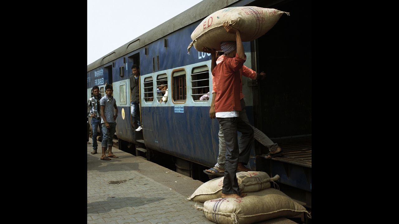 Workers load goods onto a train at Guwahati station in Assam.