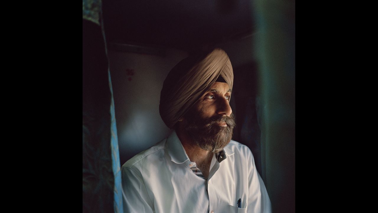 PP Singh looks out the window on the Kochuveli Express. Unlike many other Indians, Singh and his family had the luxury of traveling in second AC, which offers bedding, air conditioning and more space and privacy.