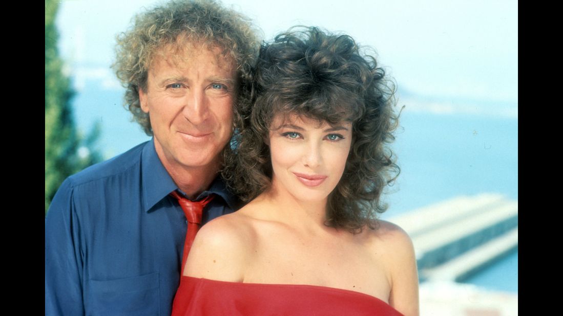 Wilder poses with actress Kelly LeBrock for a photo promoting the 1984 film "The Woman in Red." Wilder also directed.