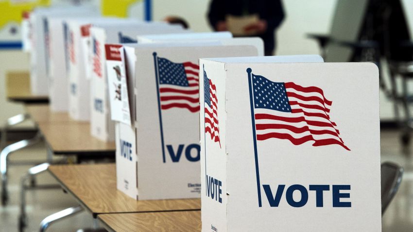 A man walks to use a voting booth March 1, 2016, at one of the Virginia primary election polling stations at Colin Powell Elementary School, in Centreville, Virginia.
Voters in a dozen states will take part in "Super Tuesday" -- a series of primaries and caucuses in states ranging from Alaska to Virginia, with Virginia the first to open its polling stations at 6:00 am (1100 GMT).  / AFP / PAUL J. RICHARDS        (Photo credit should read PAUL J. RICHARDS/AFP/Getty Images)