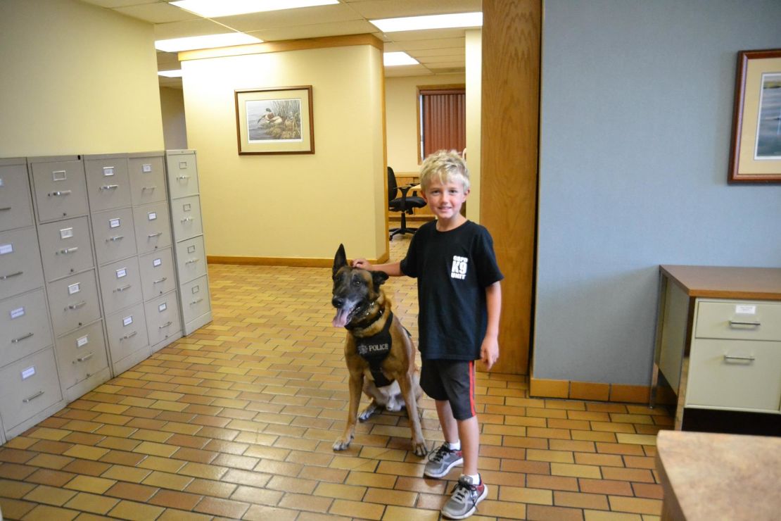 Ethan Engum poses with a police dog at K9 training. 
