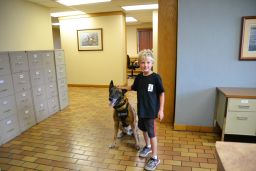 Ethan Engum poses with a police dog at K9 training 