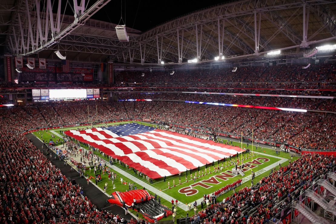 An American flag covers the field during the National Anthem before the NFL game between the Cincinnati Bengals and the Arizona Cardinals  on November 22, 2015.