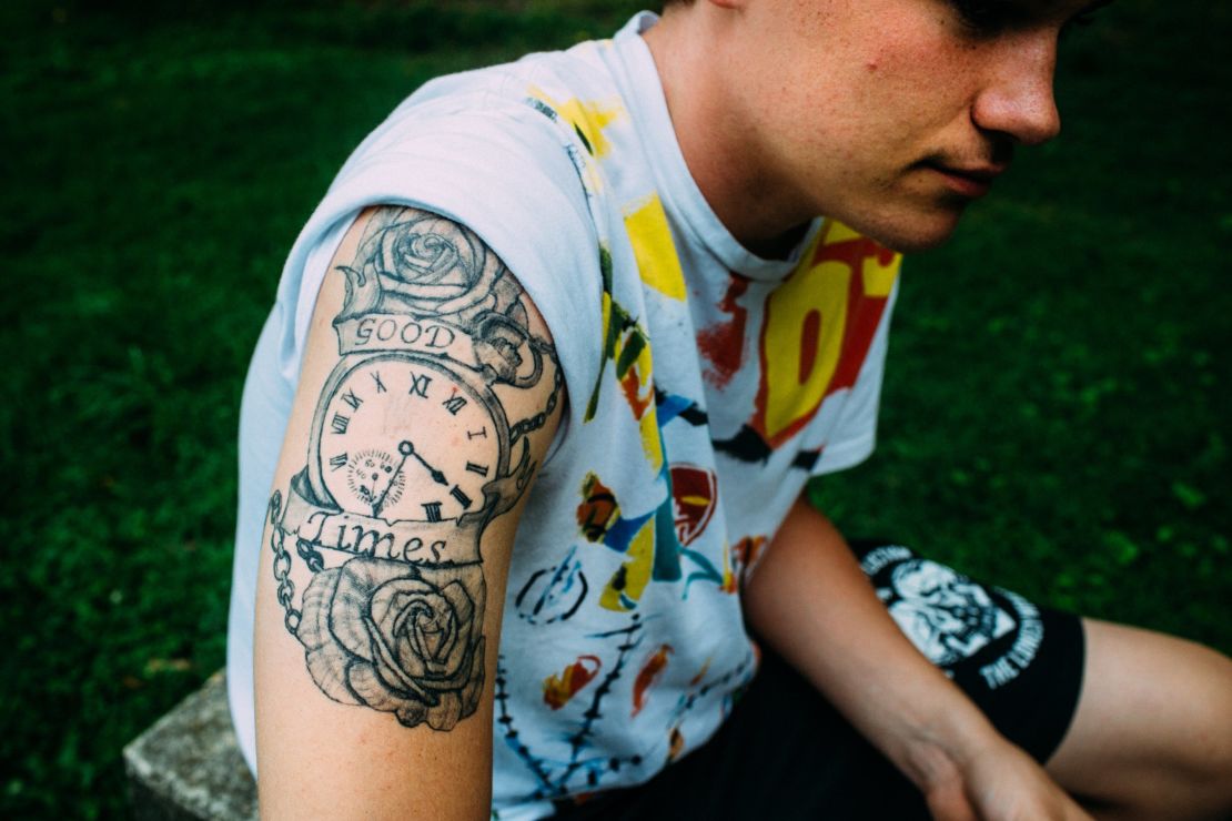 Kyle designed a tattoo with a rose that symbolizes love and hurt and a clock tepresenting the time he had with his father.