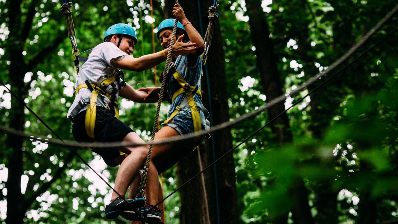 Kyle and Anaële help each other through an exercise deigned to build trust and overcome fears.