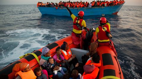 Migrants from Eritrea hold their children during a rescue operation in the Mediterranean sea, about 13 miles north of Sabratha, Libya.